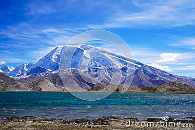 Muztagata Peak And Karakul Lake in Autumn Stock Photo